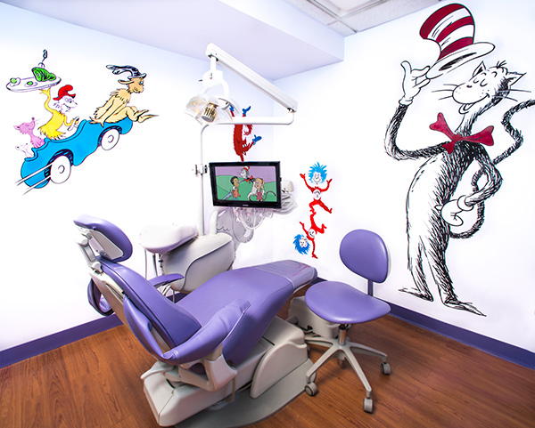 A themed dental chair with a cartoon character motif in a colorful room.